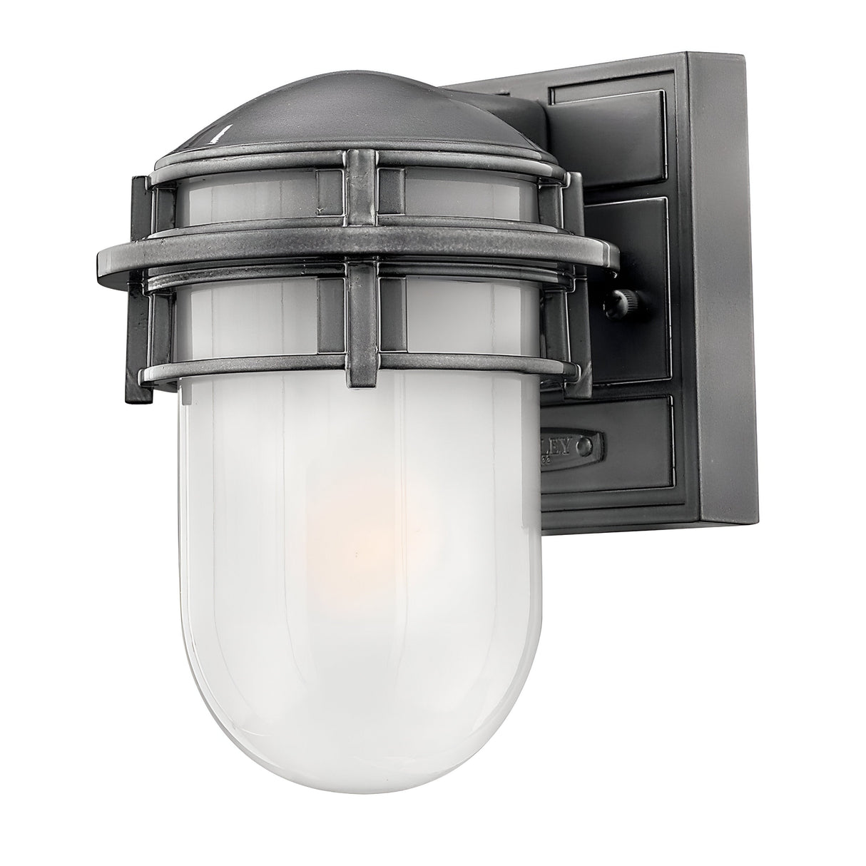 The Reef Outdoor Mini 1 Light Lantern in grey features a black metal, wall-mounted design with a caged structure that encases an opaque white glass bulb. Its industrial-style appearance is complemented by a durable cast aluminum frame, giving it the look of an outdoor mini lantern. It also boasts an IP44 rating for weather resistance.