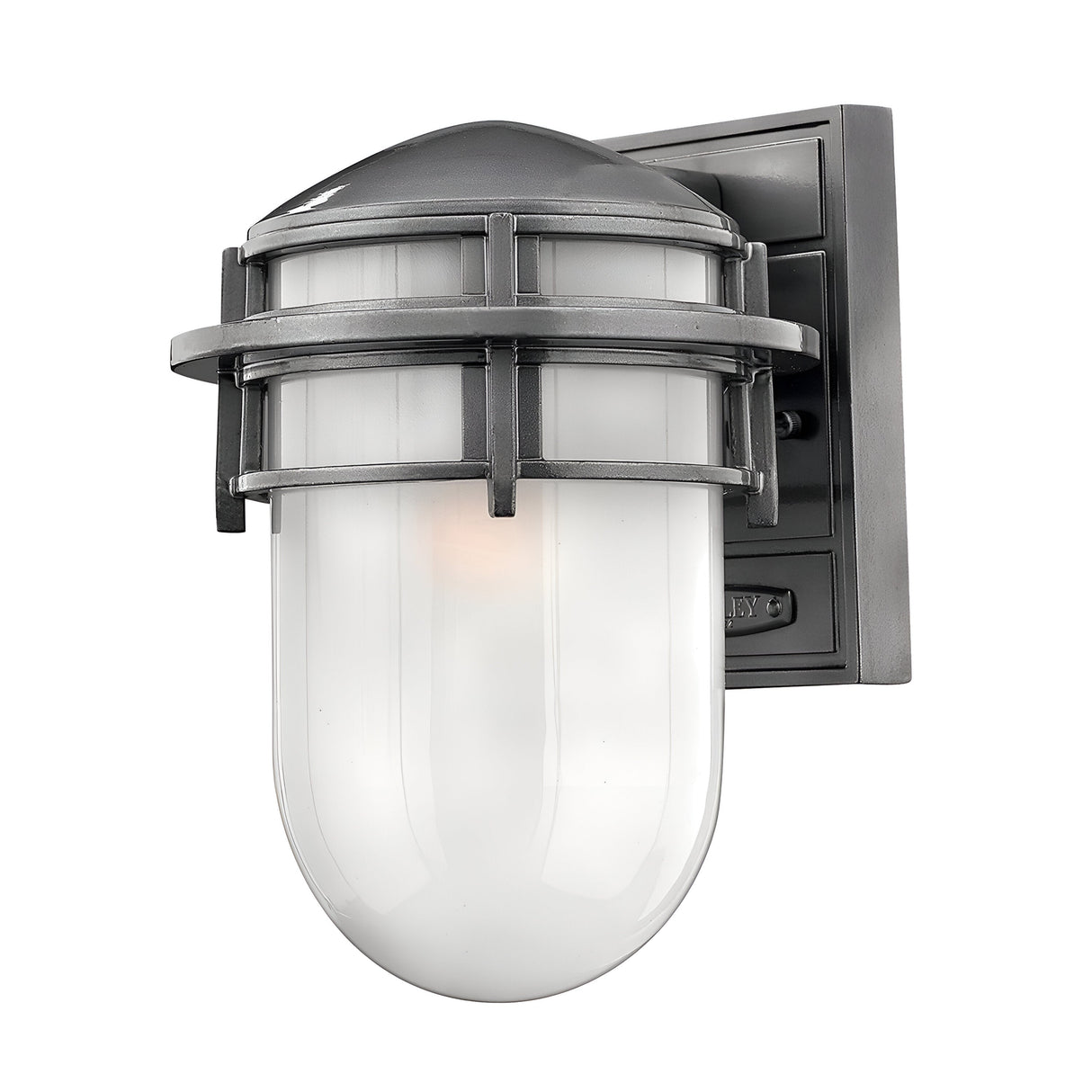 Introducing the Reef Outdoor Small 1 Light Lantern in Grey, a wall-mounted light fixture with an industrial style. It features a cylindrical white glass shade encased in a metal cage design. Crafted from cast aluminium, this fixture is supported by a square metal base with a matte finish. With an IP44 rating, it is designed for lasting appeal outdoors.