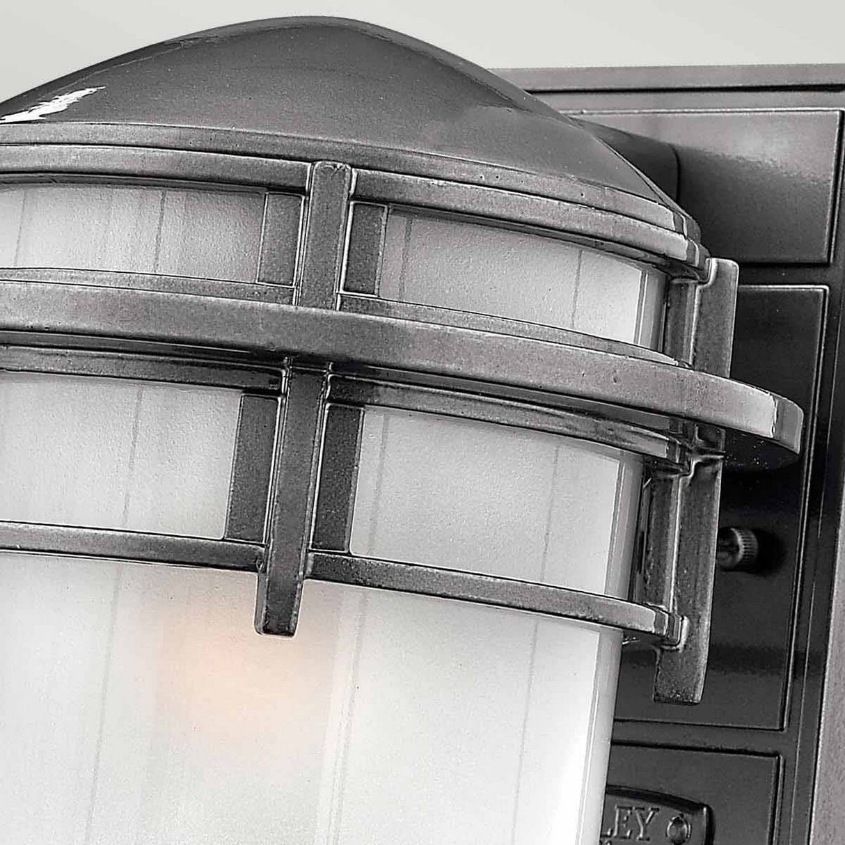 Close-up of the Reef Outdoor Small 1 Light Lantern - Grey, showcasing its dome-shaped top and frosted glass shade. This IP44-rated fixture is made from cast aluminum and features metallic crossbars for added detail.