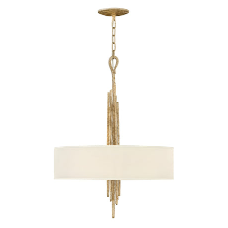 The Spyre 6 Light Pendant in Champagne Gold features a circular white fabric shade and a stylish frame with a decorative champagne gold finish. Suspended from a gold chain, it offers an elegant and modern appearance that suits various decor styles against a white background.