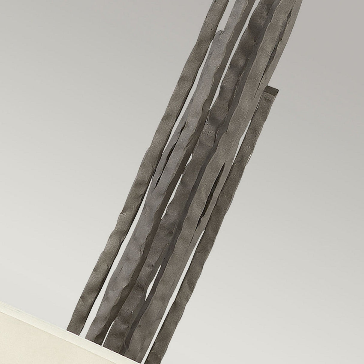 The Spyre 6 Light Pendant - Metallic Matte Bronze features several slender, wavy metallic rods extending vertically from a pale, flat base against a neutral background, capturing the sleek elegance and industrial appeal of minimalist abstract sculptures with sculptural light fixtures.