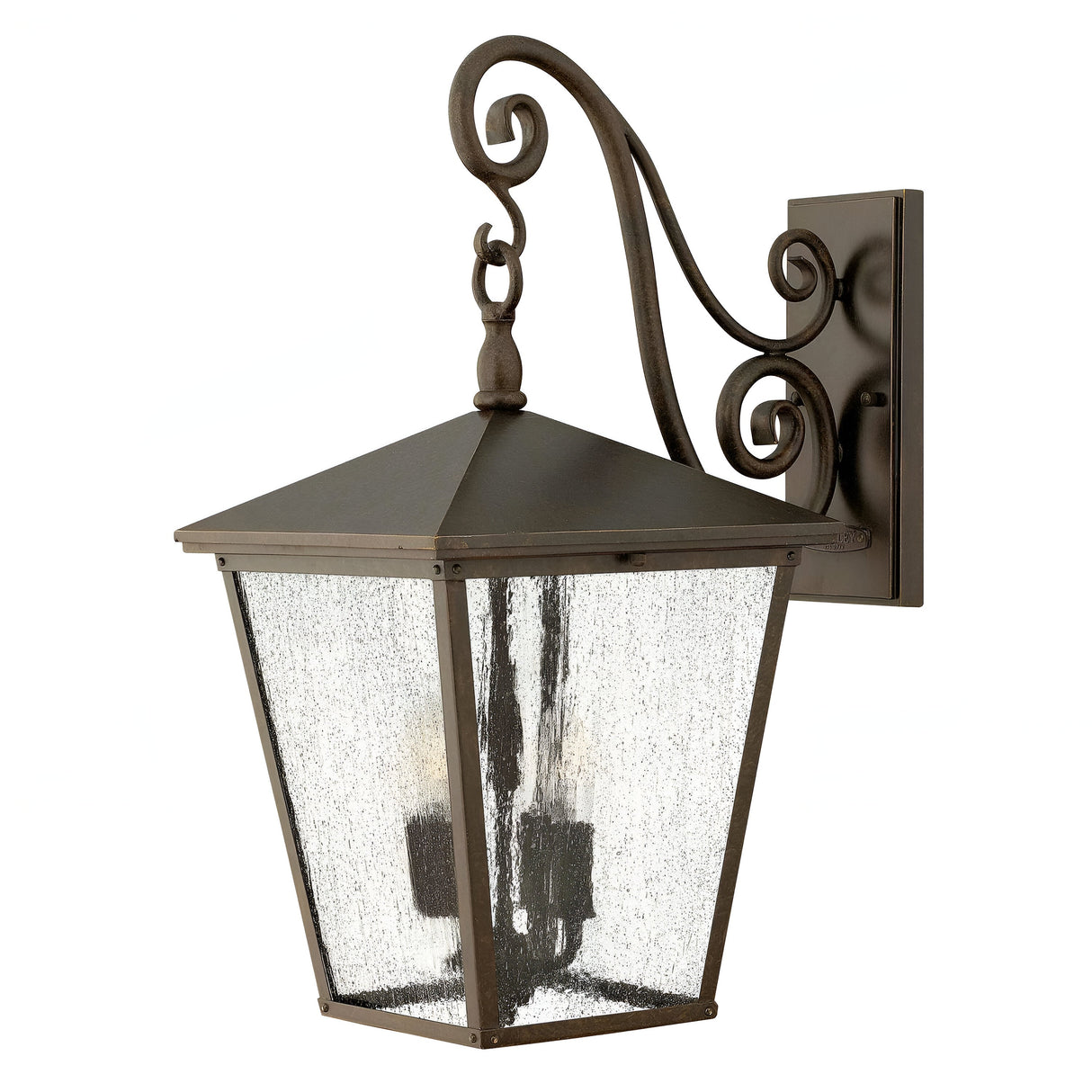The Trellis Outdoor 4 Light Large Wall Lantern in bronze features a scroll design bracket with seedy glass panels and four candle-like light bulbs inside, embodying a classic and elegant style that is perfect for enhancing your outdoor lighting setup.