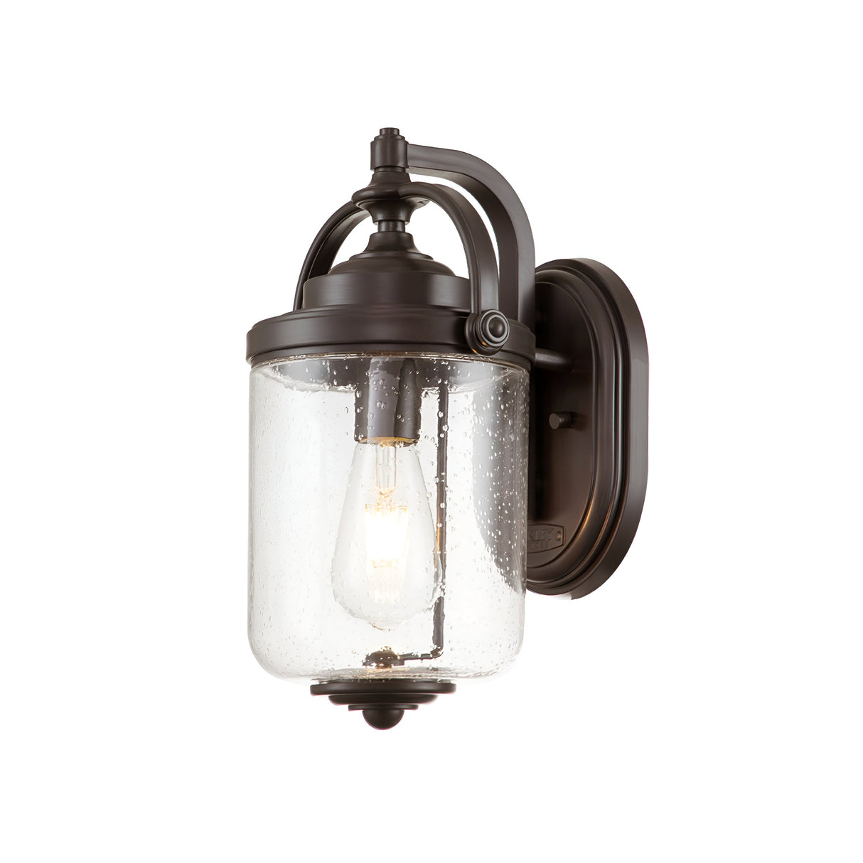 The Willoughby 1 Light Wall Lantern features a vintage-style design with an oil-rubbed bronze finish and a clear glass shade. It includes an exposed filament bulb that emits a warm glow, making it ideal for outdoor lighting while offering an elegant and classic appearance.