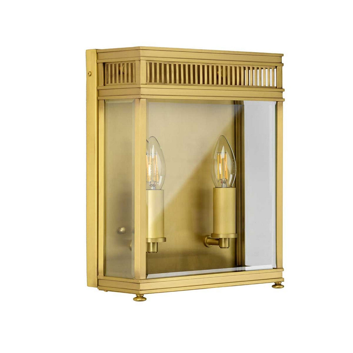 The Holborn 2 Light Outdoor Wall Light in brushed brass features a rectangular design with two exposed candle-style bulbs inside a clear glass enclosure. Its frame, inspired by Georgian design, includes a decorative grille pattern at the top.