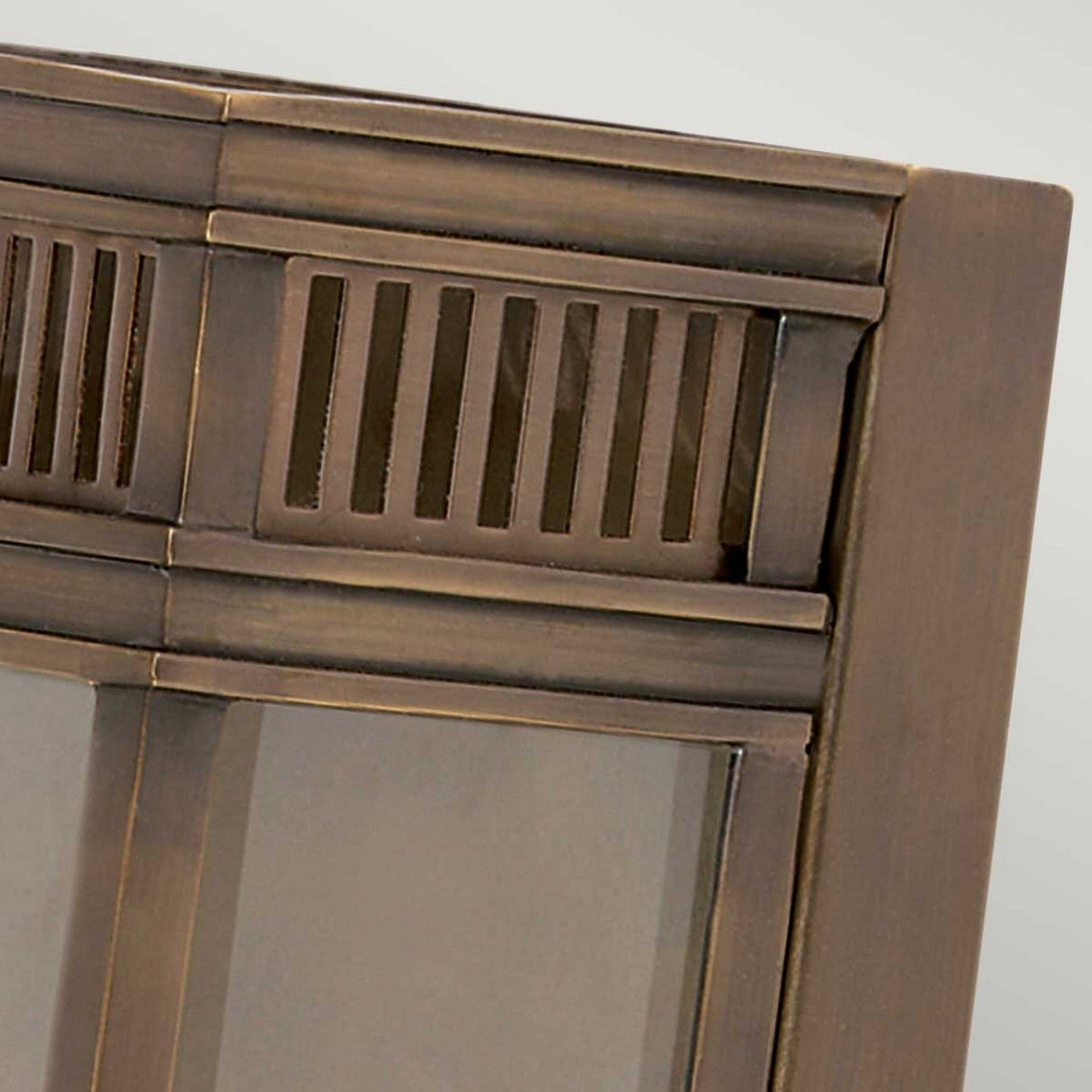 Close-up of the Holborn 2 Light Outdoor Wall Light, showcasing its dark bronze finish and rectangular glass window frame with a decorative vented top section. The design features vertical slats and a smooth finish, exuding a vintage or industrial aesthetic that enhances an outdoor wall against a neutral background.