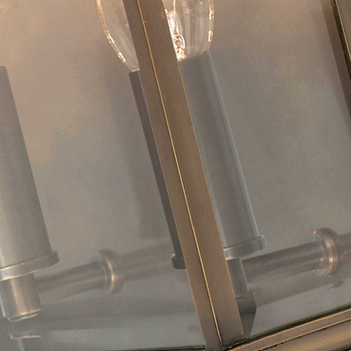 Close-up of the Holborn 2 Light Outdoor Wall Light in dark bronze, featuring a glass casing that showcases visible bulbs. The design's sleek lines and minimalist aesthetic enhance its contemporary appearance.