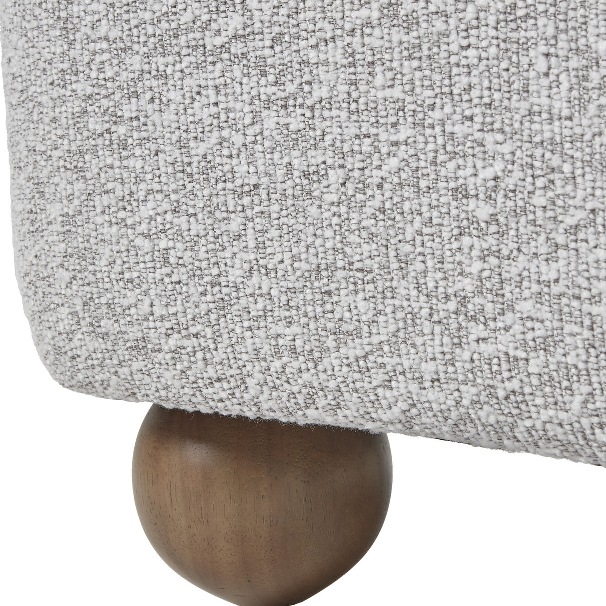 Close-up of Hill Interiors Large Arm Accent Chair showing greige-beige boucle upholstery and a rounded spherical wooden ball foot in a warm brown finish.