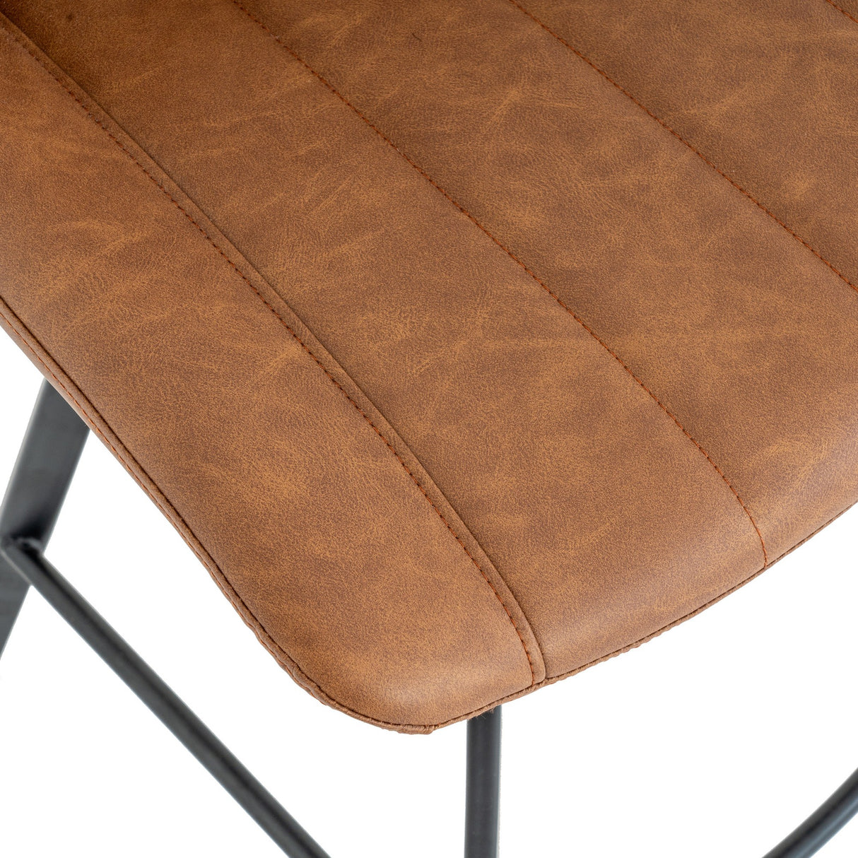 Close-up of the Hill Interiors Draxinby Tan Swivel Bar Stool showing channel-stitched tan upholstered seat and slim black metal frame.