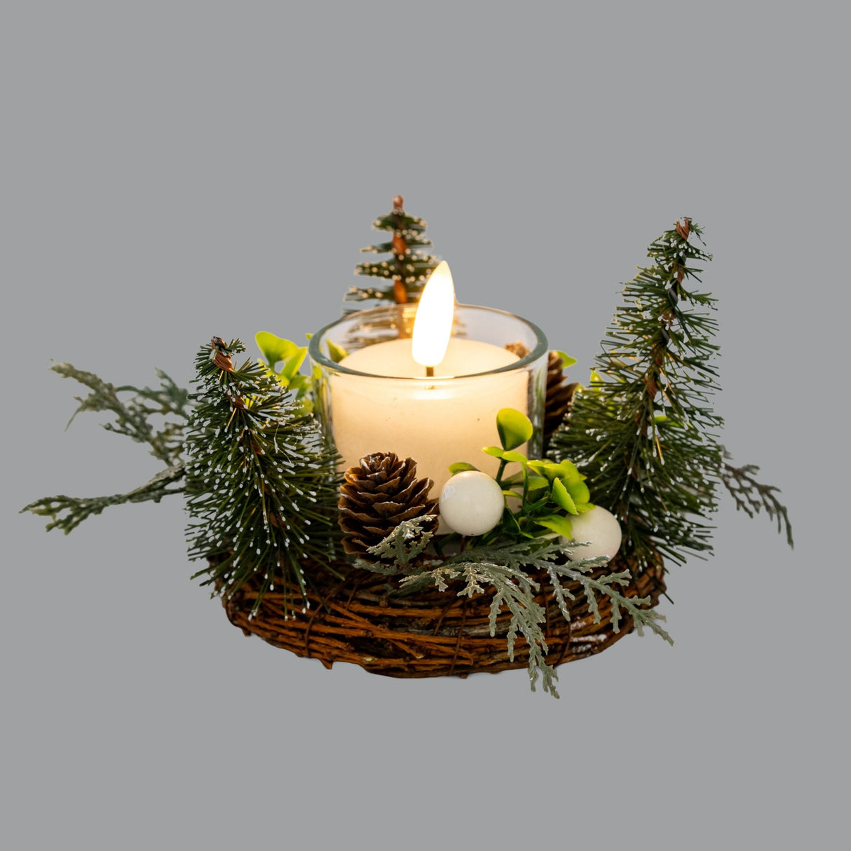 Hill Interiors Small Brush Tree Candle Wreath with Pinecones in green, twig base with mini fir trees and pinecones around a lit pillar candle.
