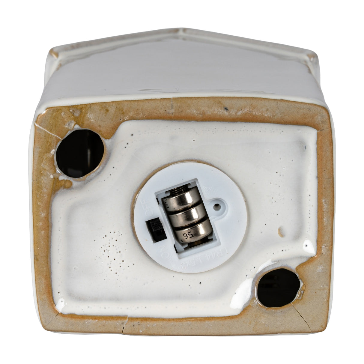 Underside view of the Hill Interiors ceramic townhouse LED light in white, showing the battery compartment and on/off switch on a plain background.