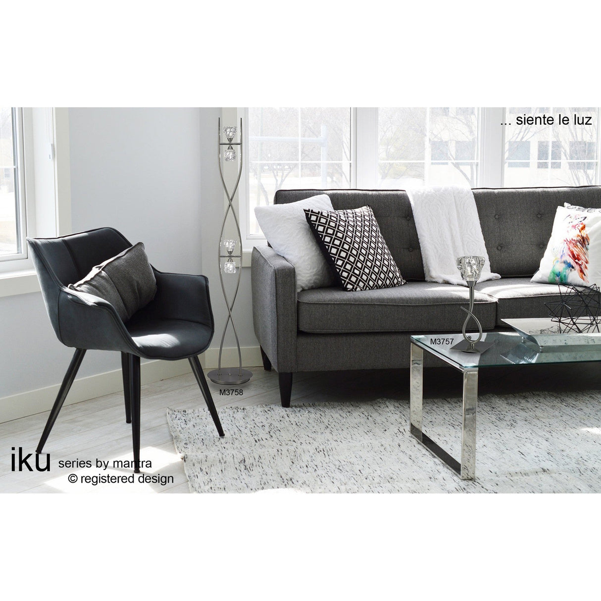 A modern living room with a gray sofa, patterned pillows, a black armchair, and a glass coffee table. Sunlight streams in as the Iku 4 Light Floor Lamp in satin nickel adds style to the bright space. Text overlays appear on screen.
