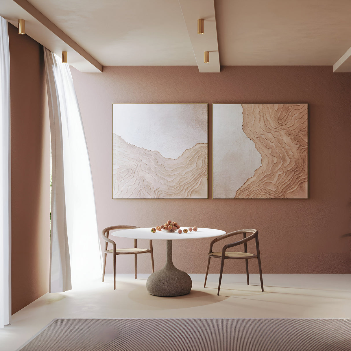 A minimalist dining area features two wooden chairs, a fixed round table with a small centerpiece, soft beige walls, large abstract art pieces, and sheer curtains. It is elegantly lit by the Focus Fixed Round Surface Mounted Downlight in matte gold.