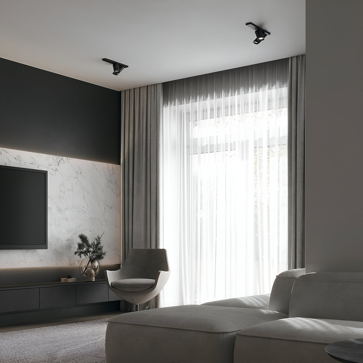 A sleek modern living room showcases a flat-screen TV on a marble-accented wall, with the Focus S Twin Bar Spotlight in black highlighting the contemporary gray chair and plush sectional sofa. Sunlight streams through sheer curtains at a tall window, creating an airy ambiance.