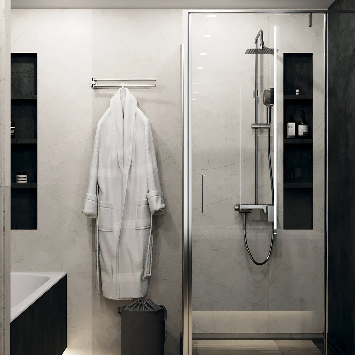 The bathroom showcases a glass shower enclosure, a white robe on a wall rack, and recessed shelves with toiletries. Stockton CCT 12W LED downlights offer perfect illumination, while color temperature control enhances ambiance. A bathtub peeks from the left against light marble walls.