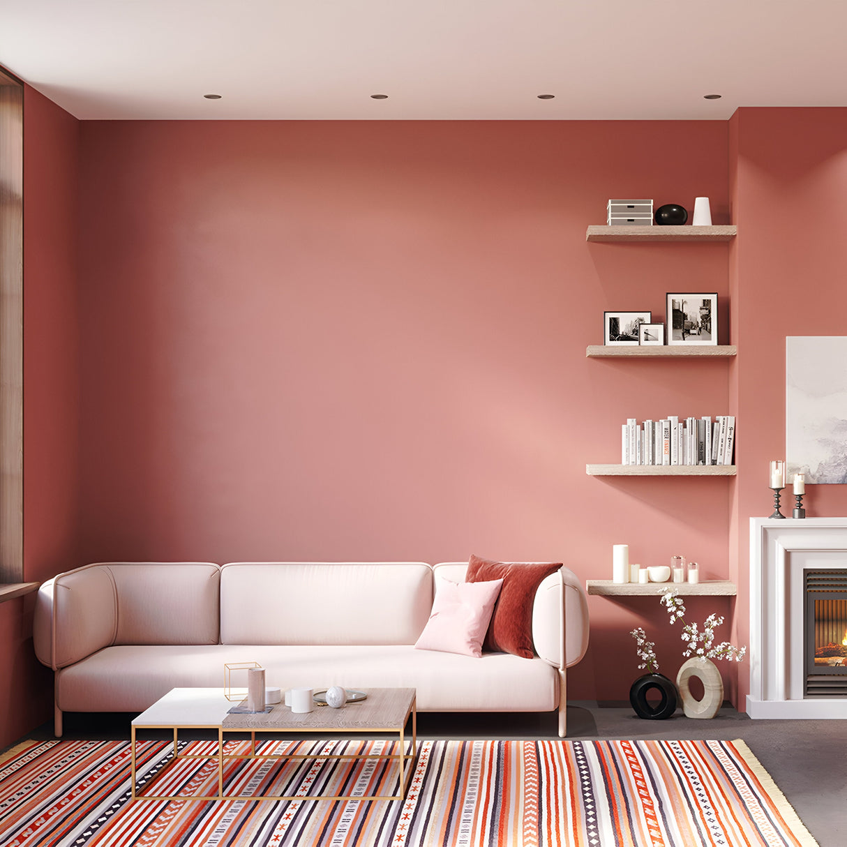 A stylish living room with pink walls boasts a light pink sofa, pillows, striped rug, modern coffee table, shelves of books and decor, and a fireplace. Contemporary Yin Round Recessed Downlights in black offer dimmable lighting as natural light streams in from a large window on the left.