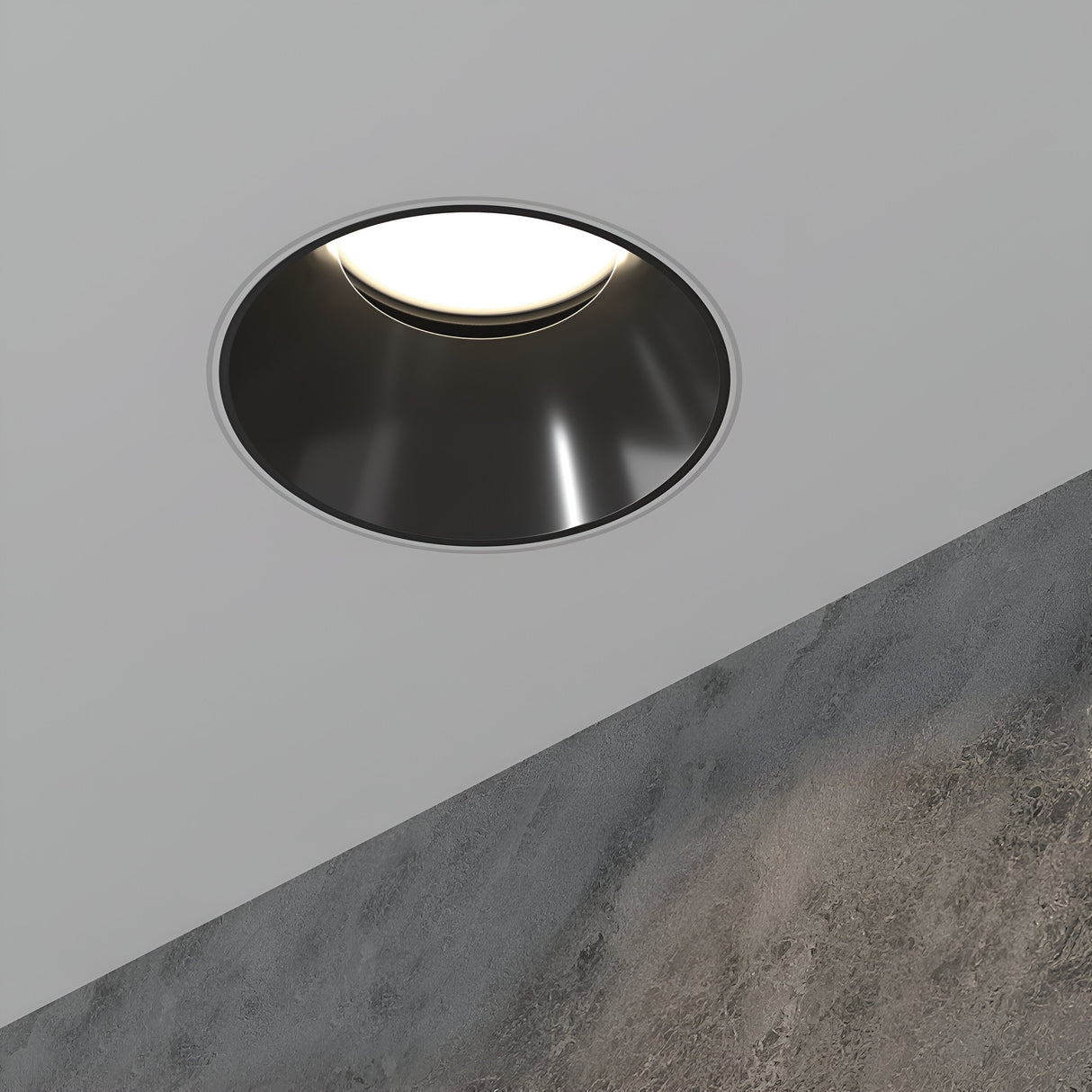 The Share Round Plaster-in Recessed Swivel Downlight in White and Black emits a soft white glow. Its swivel mechanism suits both smooth and textured ceilings, creating a modern, minimalist look.