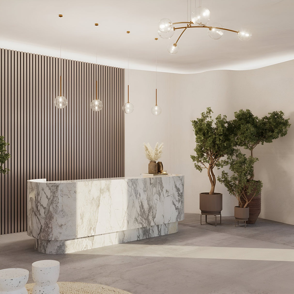 A modern reception area showcases a marble desk and the Mood 6 Light Suspension with brass fixtures and clear glass shades. Large potted plants outline the space, while vertical wood paneling adorns one wall. The light-colored floor complements the minimalist aesthetic.