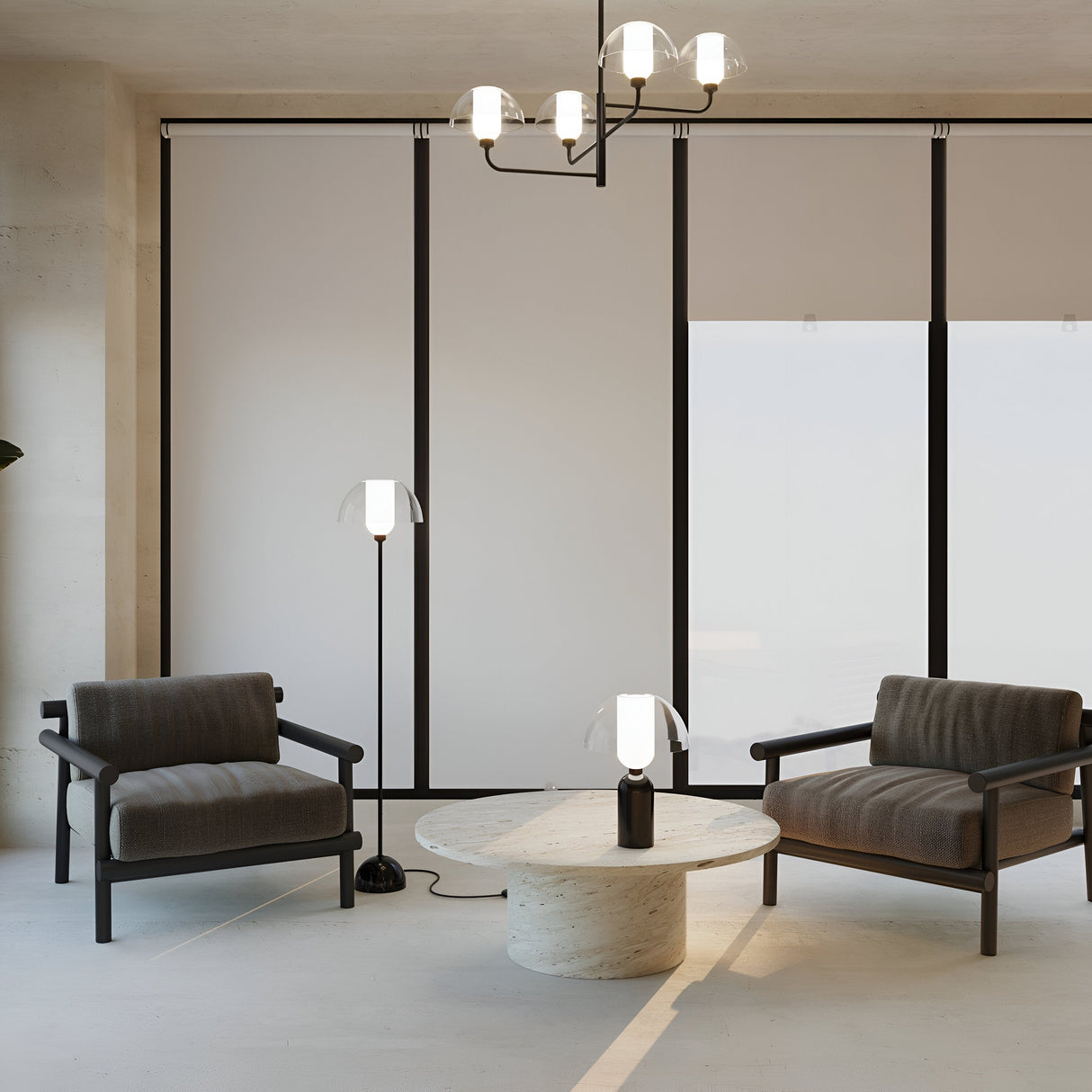 A minimalist room features two dark armchairs facing a round marble coffee table. The Memory Floor Lamp in black with an opal white glass shade is lit alongside a table lamp. A modern chandelier hangs overhead, and large windows complete the background.