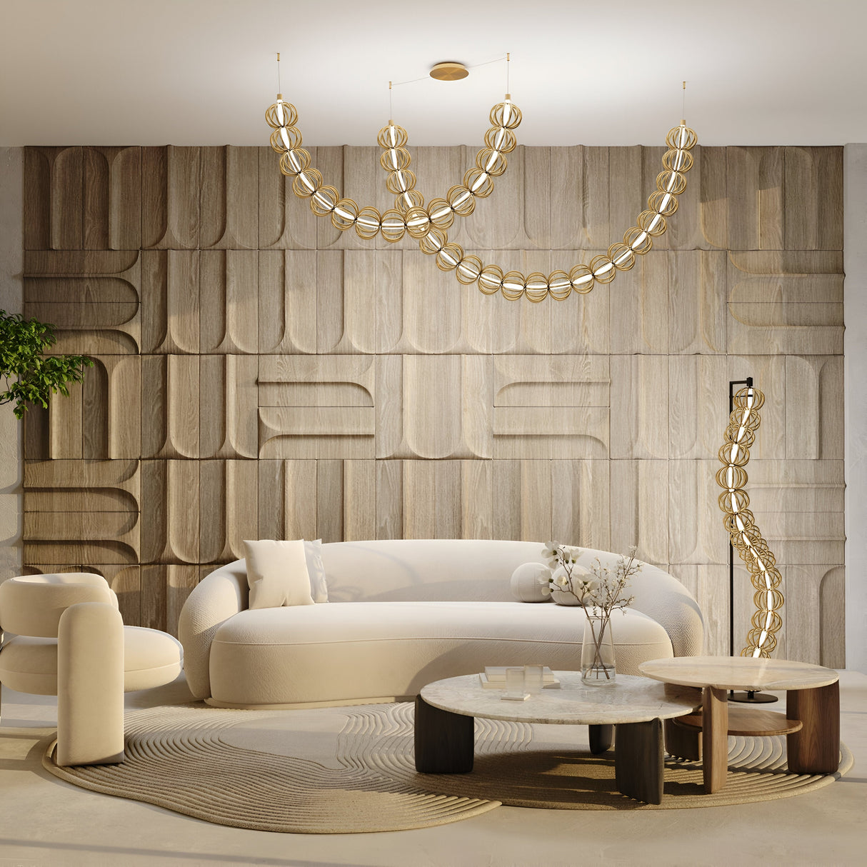 A modern living room features a curved white sofa, round marble coffee tables, and a unique wooden panel wall. Two Golden Cage LED Cord Wire Surface-Mount Suspension Lights in gold provide ambient lighting. A plant adds greenery to the elegant, minimalistic space.