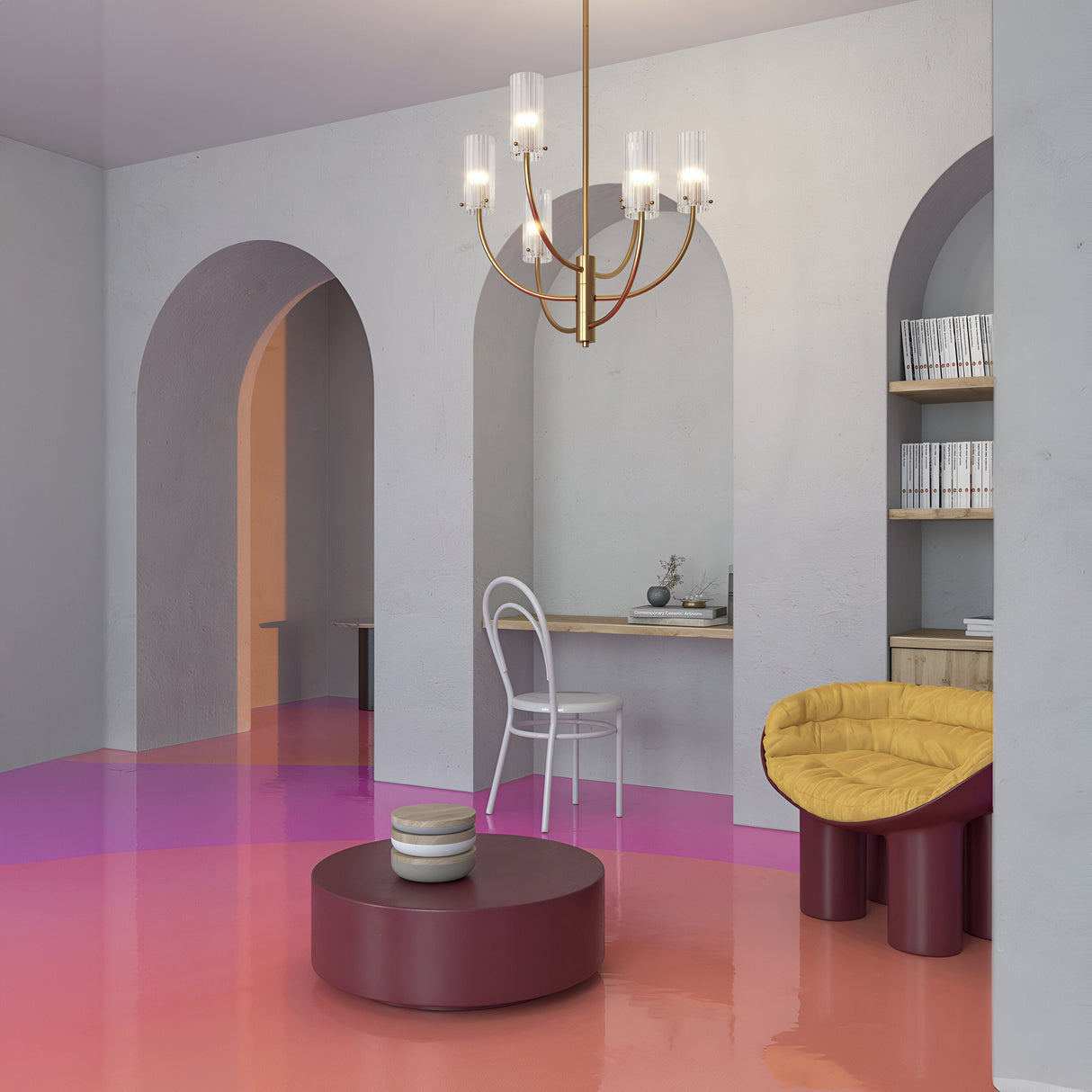 Modern interior featuring arched doorways, a pink and orange gradient floor, the Arco 3 Light Chandelier - Brass with ribbed glass lampshades, a white chair at a small desk, and a mustard-yellow cushioned chair beside a round burgundy coffee table. Shelving with books is in the background.