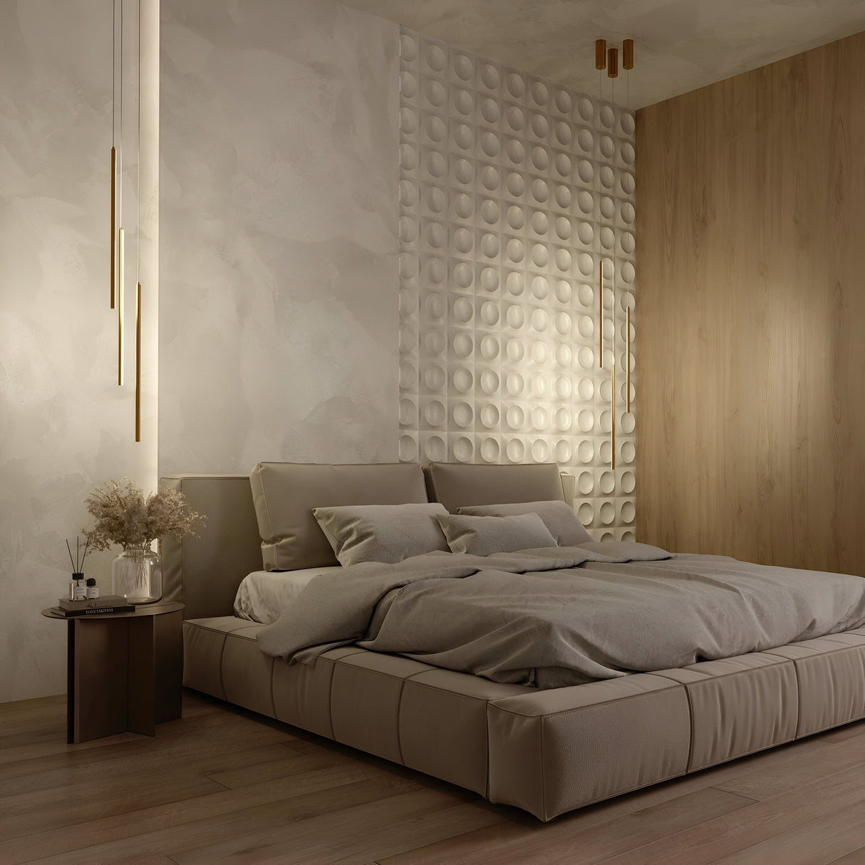 A modern bedroom features a low, beige bed with neutral bedding. Textured walls include circular designs and a wooden accent wall. Halo Dimmable LED Short Slim Pendant Lights in brass hang on each side, and a small table with dried flowers sits next to the bed.