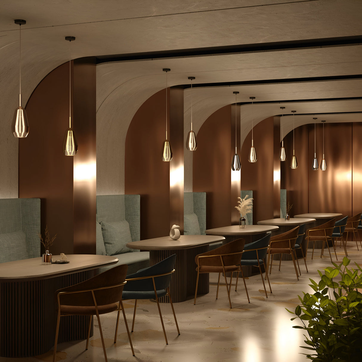 The modern cafe interior features a row of tables and chairs against a wall adorned with arched mirrors. Duality Teardrop Pendant Lights with coffee glass shades add elegance, while soft teal upholstery contrasts beautifully with brown walls, and green plants offer a refreshing touch.