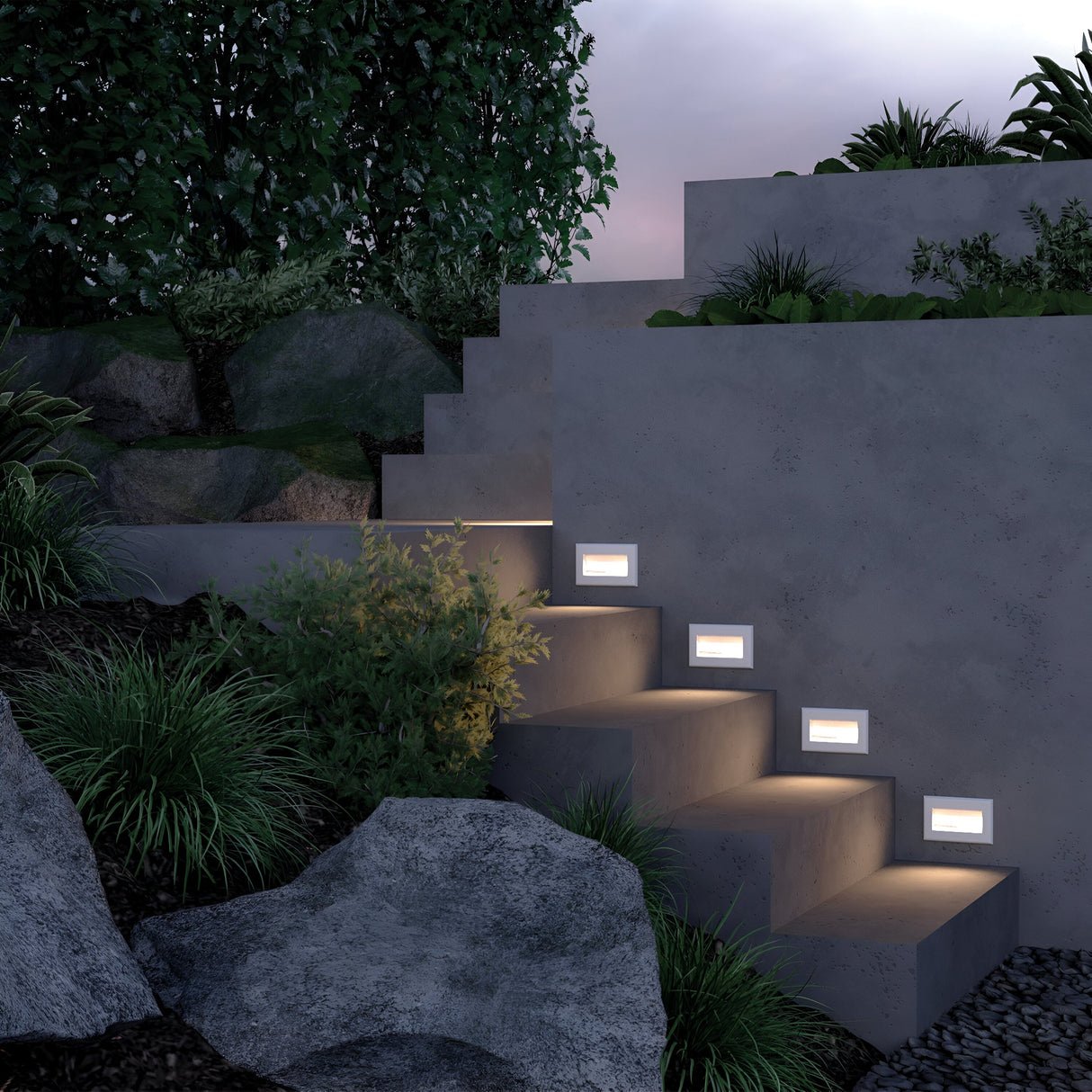 Outdoor concrete steps with Bosca Outdoor LED Recessed Wall Lights in white lead to a raised terrace, exuding modern elegance. Lush greenery encircles the steps alongside bushes and rocks. Energy-efficient lights create a dusk ambiance under a soft purple sky.