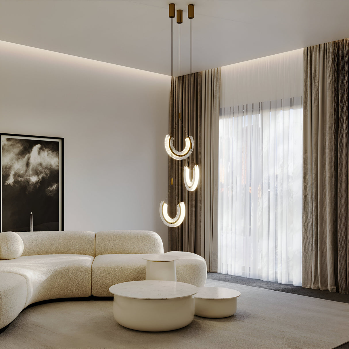 A modern living room with a large white curved sofa, two round marble coffee tables, and the Maya LED Glass Pendant Light - Gold. Sheer curtains with drapes frame the space, while a dark-framed artwork of abstract shapes completes the look.