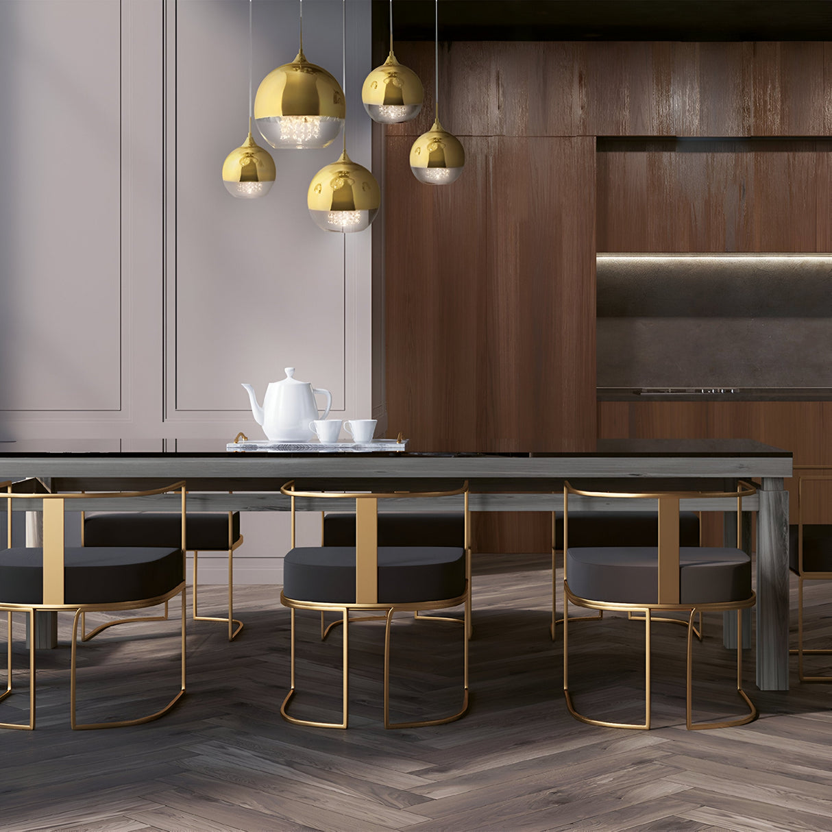 A modern kitchen showcases a sleek design with the Fermi 5 Light Cluster Pendant in gold. It includes a dark wooden table, matching chairs with gold frames, and a white teapot and cups. Wooden cabinetry and a built-in oven complete the elegant setting.