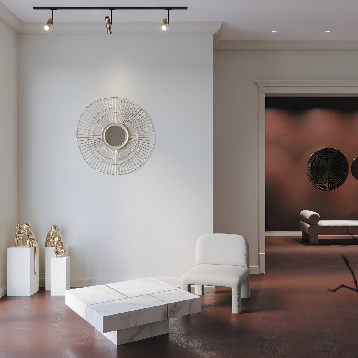Modern living room with a minimalist design featuring a white armchair and geometric marble table. A large, circular wall decoration and two bronze sculptures accent the space. The black & gold Elti Single Phase Unity Track Spotlight illuminates the area, enhancing the ambiance perfectly.
