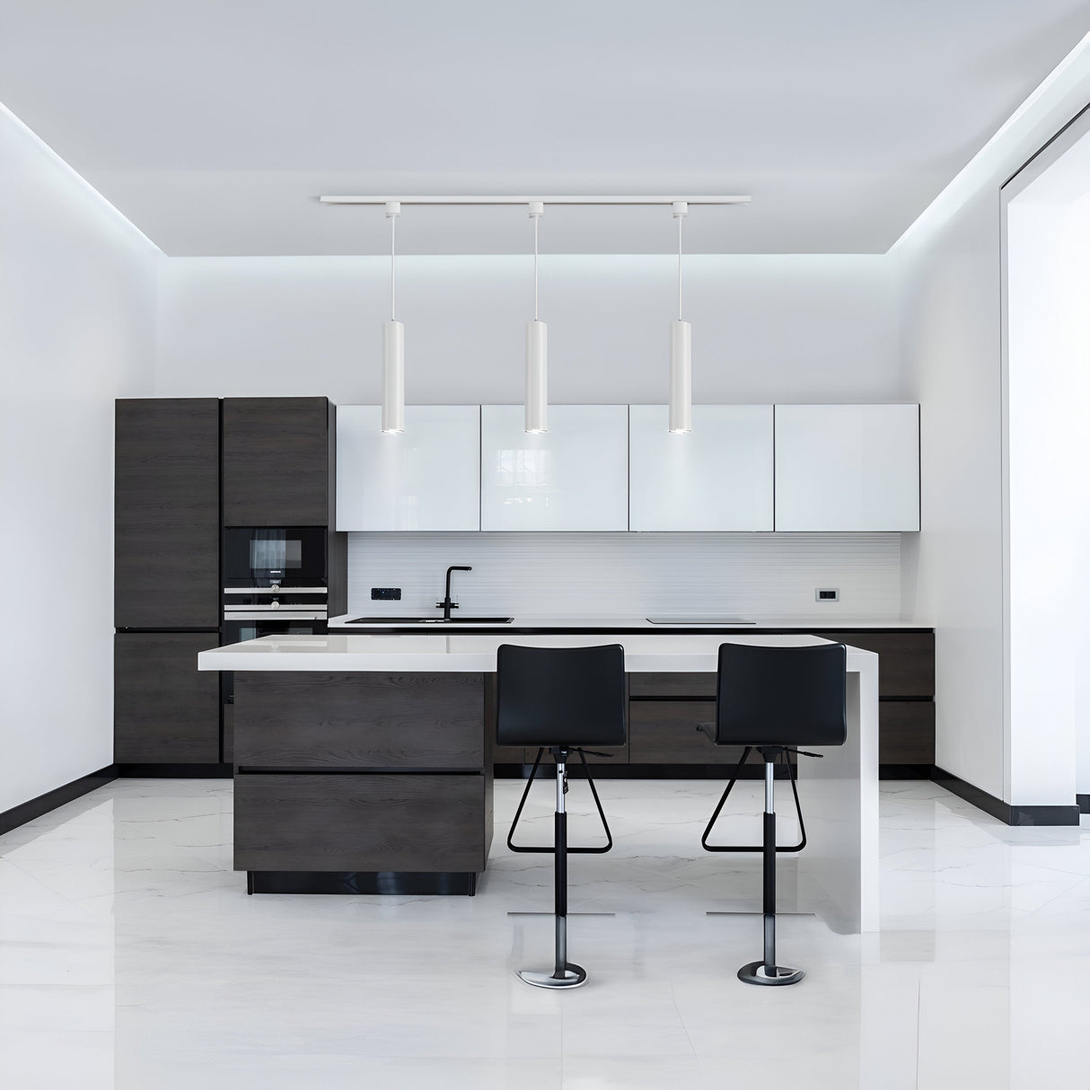 A modern kitchen with dark wood cabinets and white countertops features two black bar stools at the island. Three Focus Single Phase UNITY Track Pendant Lights in white hang above, enhancing the modern industrial aesthetic. The floor is tiled in white, completing the sleek and minimalist design.