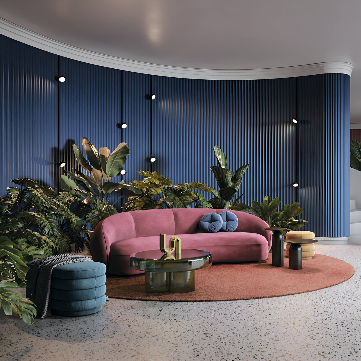 A modern living room includes a pink curved sofa with pillows on a circular brown rug, surrounded by a green glass coffee table and cylindrical side table. The blue textured wall features plants, round lights, and the Rado CCT LED Dimmable Magnetic Exility Track Spotlight for adjustable ambiance.