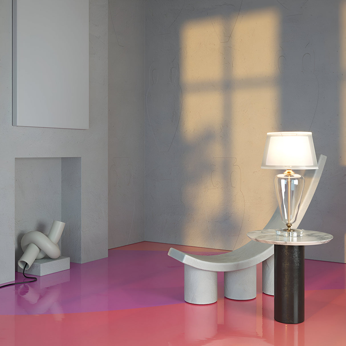 A minimalist room features a modern chair and a small round table with the Verre Table Lamp - Brass With Clear Glass Base & White Linen Shade. The floor displays a pink gradient. In the corner, theres a sculpture. Sunlight creates window-shaped shadows on the neutral wall with subtle vase patterns.