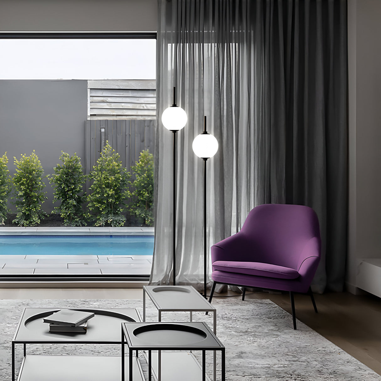 A modern living room with a purple chair, glass coffee tables, and The Sixth Sense 2 Light LED Floor Lamp 3000K 12W - Black. With a minimalist design, large windows with sheer gray curtains provide views of the swimming pool and lush greenery outside.