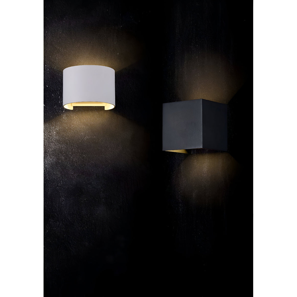 Two wall-mounted lights on a dark wall: a Fulton Outdoor LED Oval Wall Light in white on the left and a square black light made from corrosion-resistant aluminum on the right. Both cast up-and-down beams, creating a subtle glow and showcasing energy-efficient lighting.