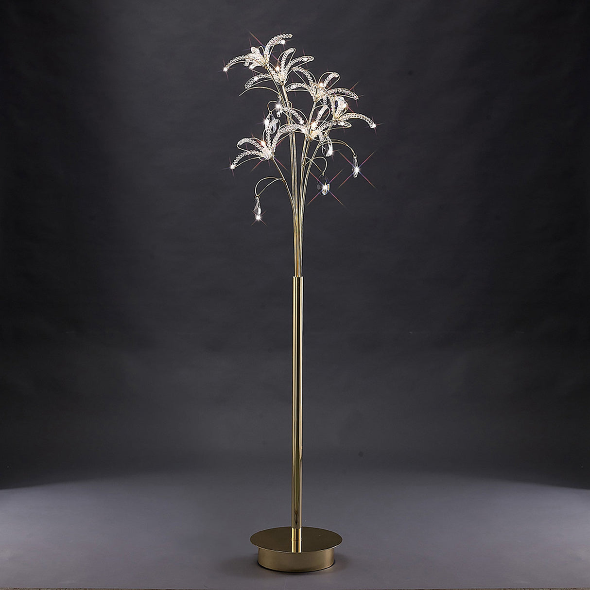 The Kenzo 6 Light Crystal Floor Lamp in French Gold features a gold stand with multiple curved branches and crystal accents, creating a luxurious, tree-like statement piece perfect for elegant spaces.