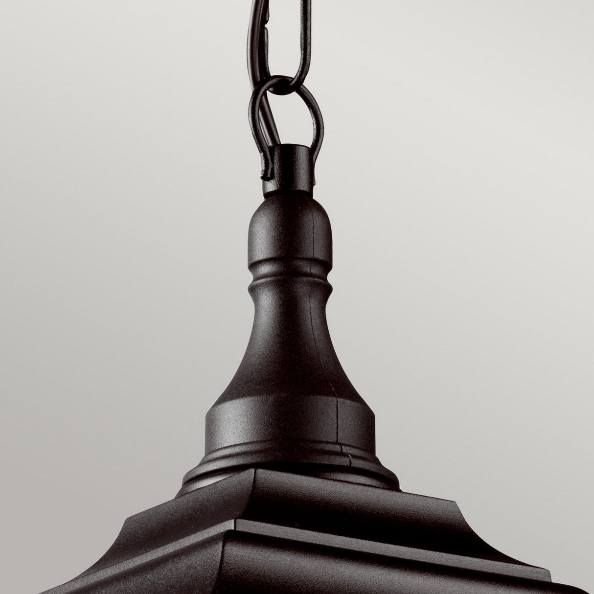 Close-up of the Kerry 1 Light Outdoor Chain Light - Black, an elegant fixture featuring a decorative hook at the top. This corrosion-proof light showcases smooth curves and sharp edges, providing a classic look against a neutral background.