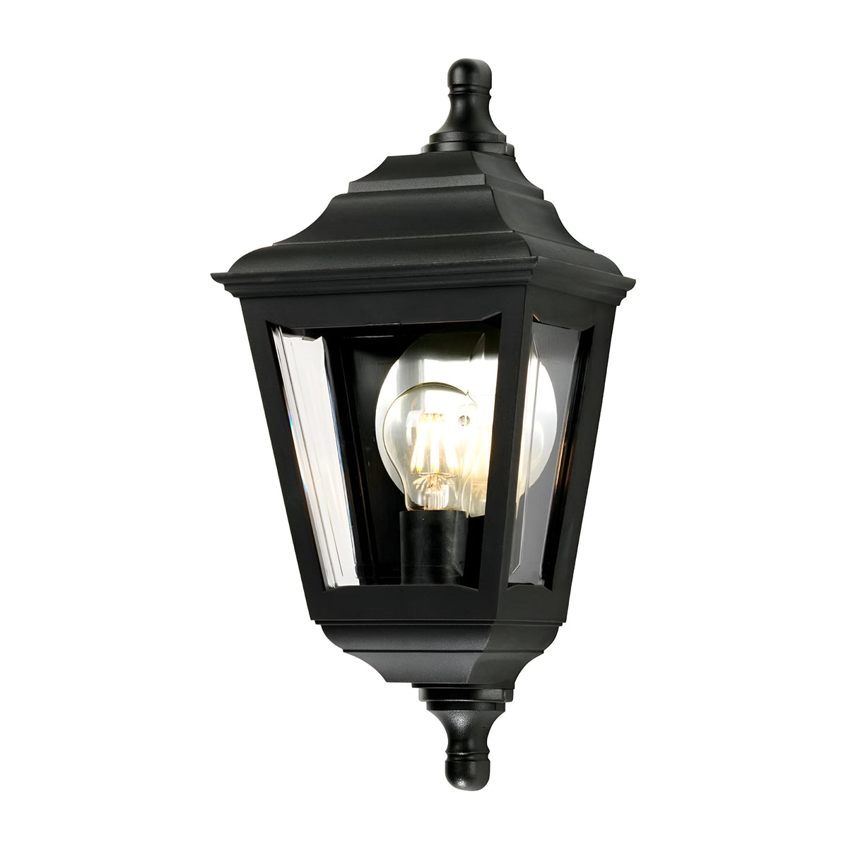 The Kerry 1 Light Outdoor Flush Wall Light in black showcases a vintage design, featuring a clear glass cover that reveals the light bulb inside. This corrosion-proof fixture boasts a classic, tapered look with decorative finials at the top and bottom, offering both style and durability for your outdoor space.