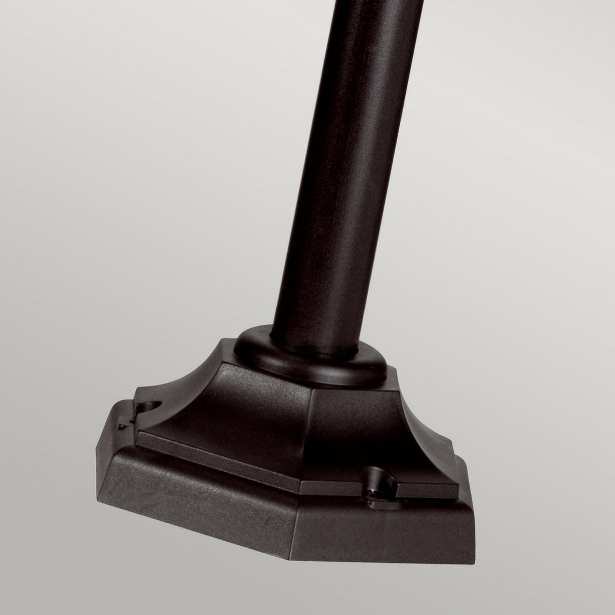 A close-up of the Kerry 1 Light Lamp Post in black showcases its corrosion-proof metal finish and square base against a light gray background. The base features an elegant, ornamental, tiered design, enhancing this piece of outdoor lighting.