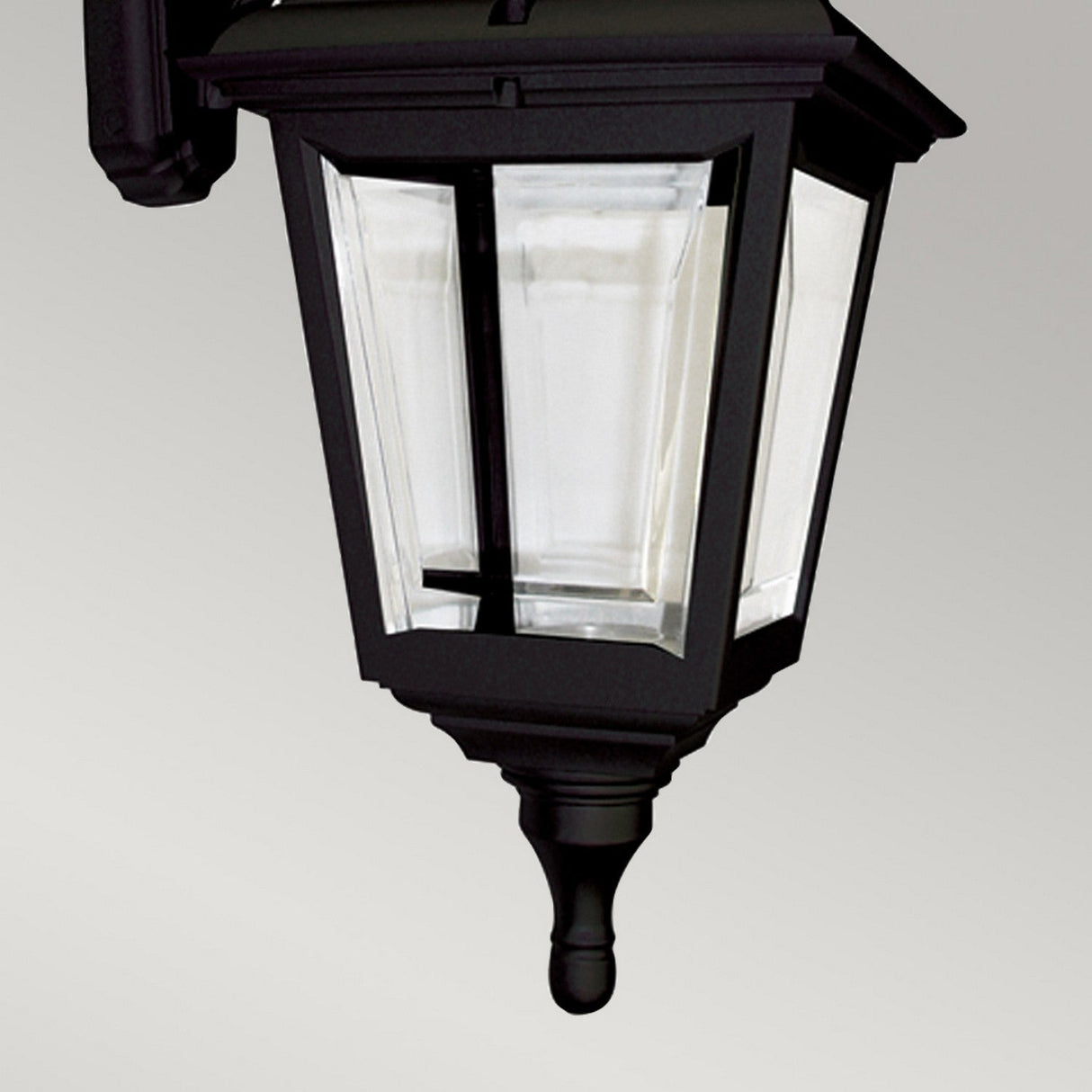 The Kerry 1 Light Outdoor Wall Light in black features a classic rectangular design with clear glass panels. This IP44-rated lantern is made of corrosion-proof black polymer and includes a decorative finial at the bottom, mounted on a bracket for easy installation.