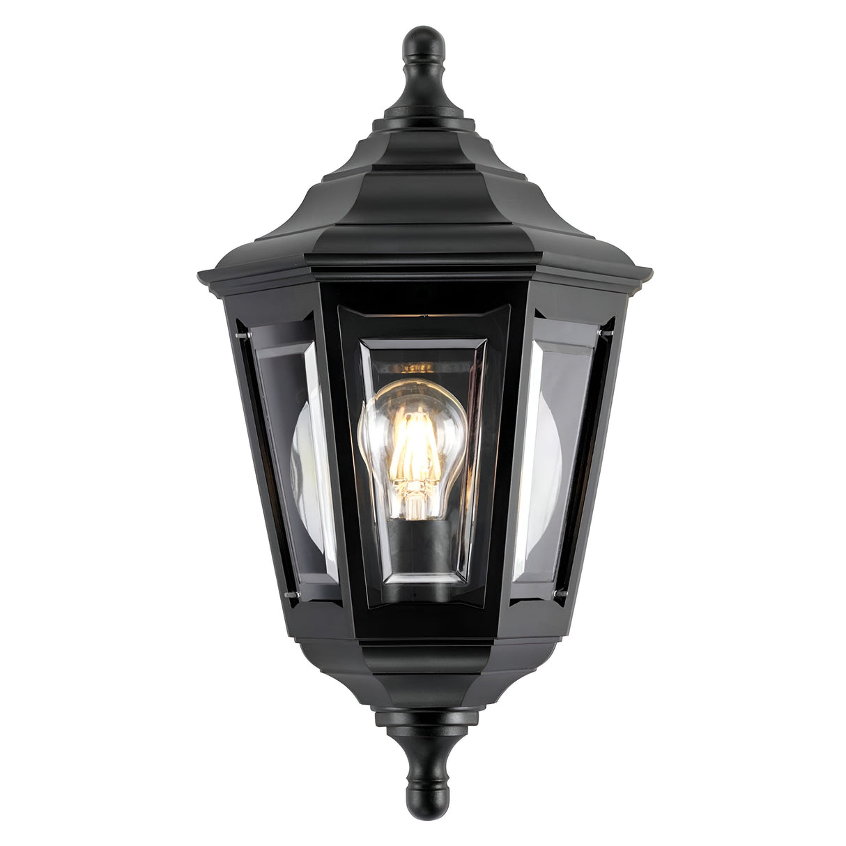 The Kinsale-1 1 Light Outdoor Wall Light in black is a classic outdoor wall lantern that is weather-resistant and corrosion-proof. It features a transparent glass frame encasing a lit light bulb, complete with a pointed top and decorative finial, making it an ideal choice for traditional exterior decoration.