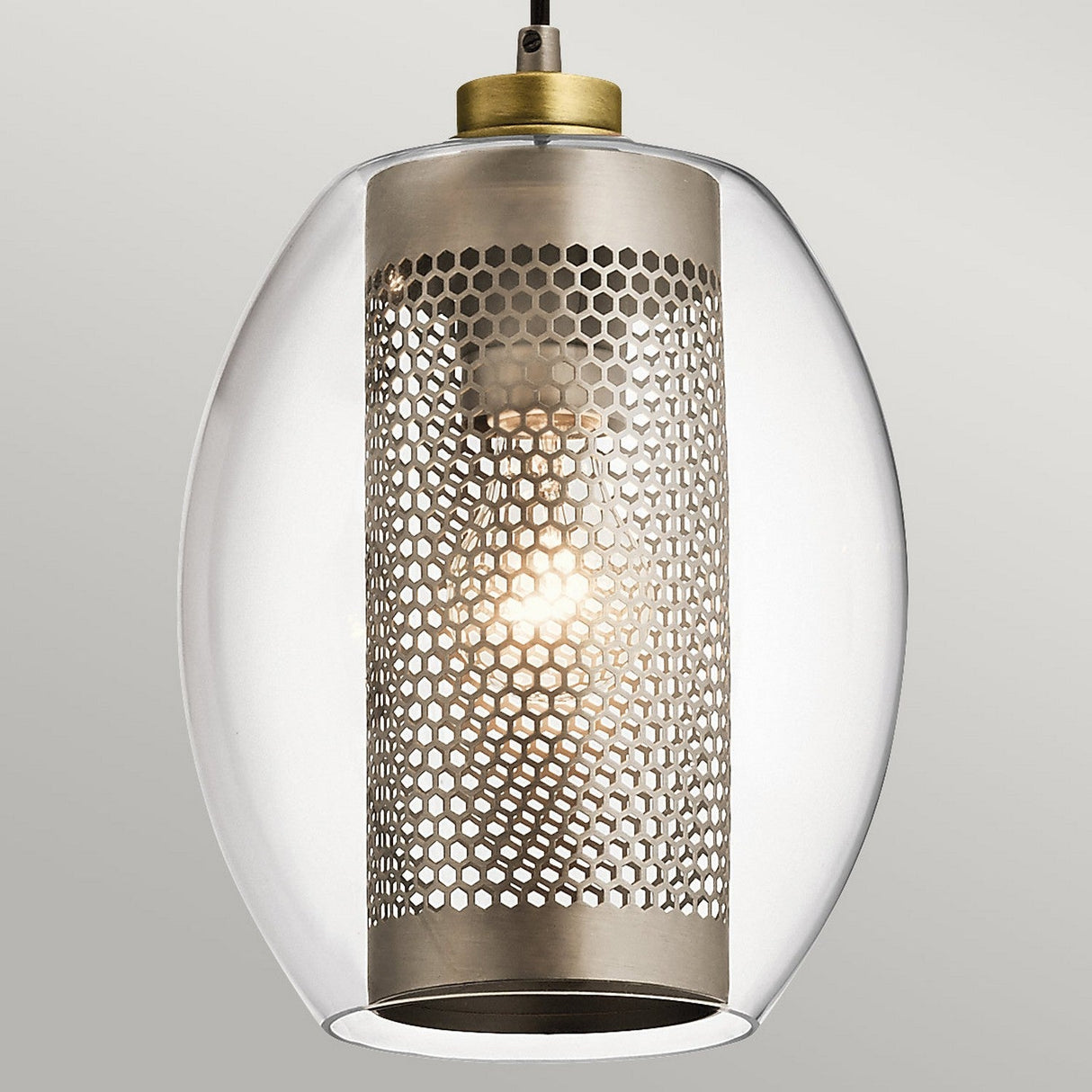 Introducing the Asher 3 Light Pendant Rectangle - Silver: a perfect blend of contemporary style and industrial lighting. This fixture showcases a sleek, clear oval glass shade enveloping a cylindrical metal mesh, casting a warm glow through its perforated pattern while being elegantly suspended from above.