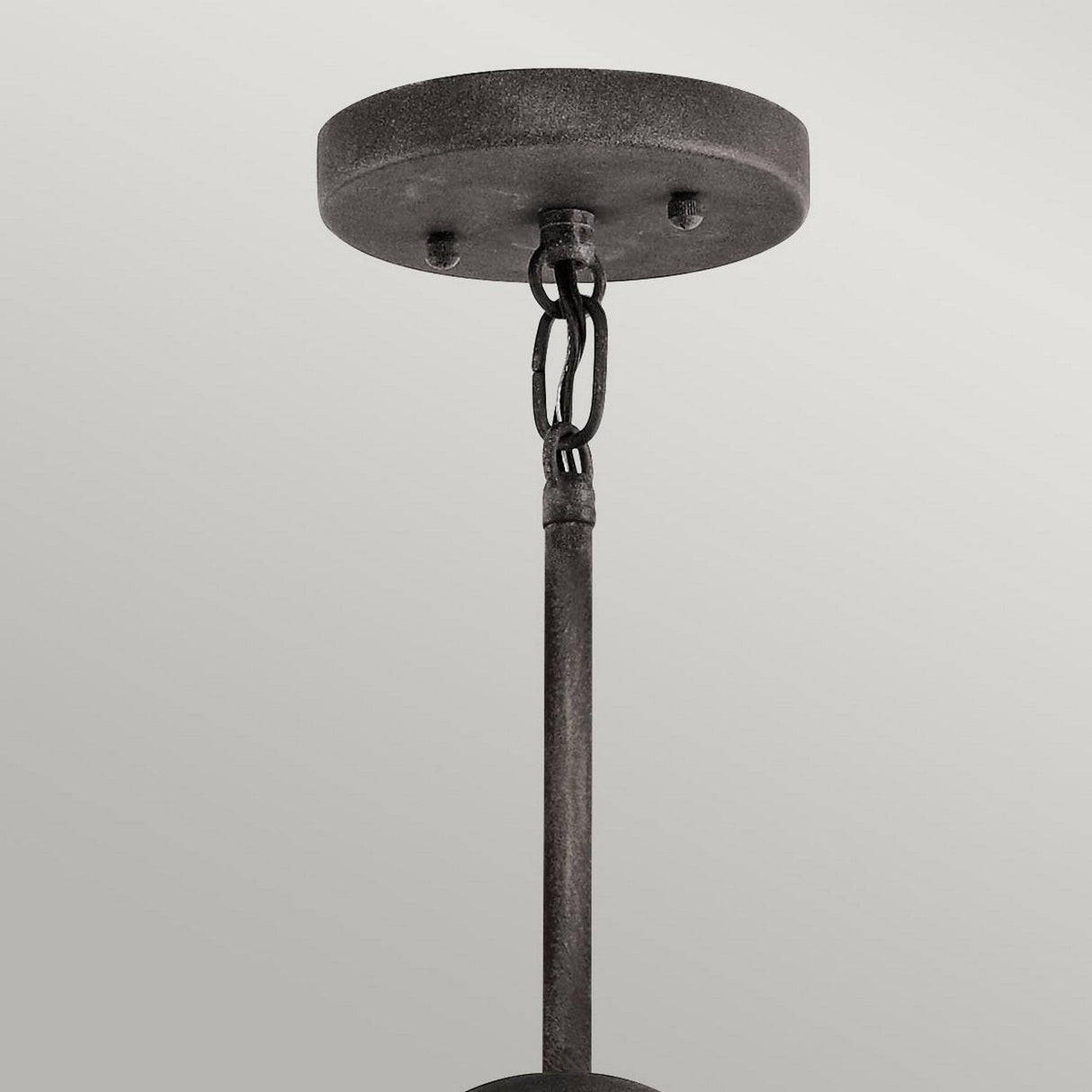 A close-up view of the Ashland Bay Outdoor 5 Light Chandelier - Weathered Zinc, featuring a ceiling-mounted fixture with a weathered zinc canopy, chain links, and a rod hanging down against a light gray background. The chandelier exudes an industrial, rustic appearance with vintage ambiance.