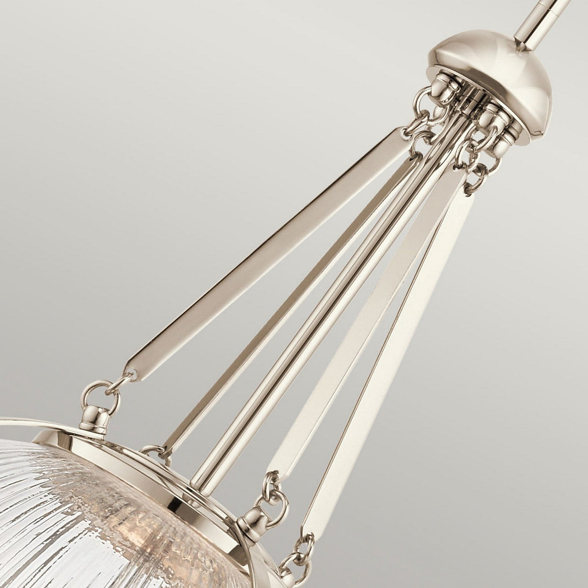 Close-up of the Aster 3 Light Pendant - Polished Nickel, showcasing sleek metal rods and ribbed glass domes. The intricate metalwork in polished nickel enhances its contemporary and elegant design, resulting in a stunning modern chandelier look.