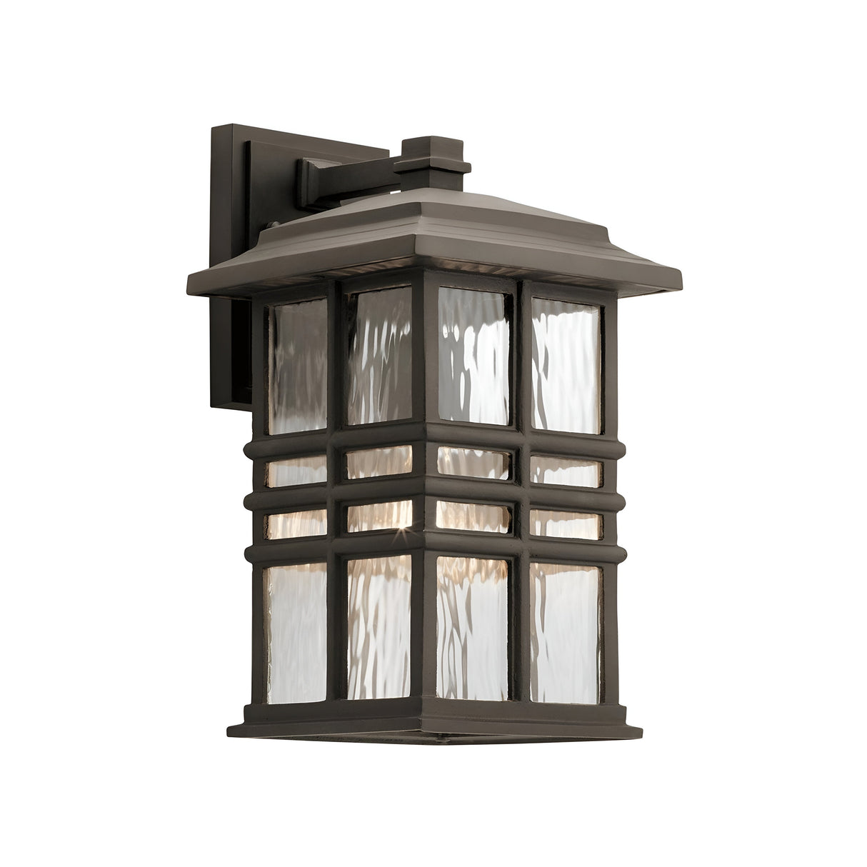 The Beacon Square Outdoor 1 Light Medium Wall Lantern in bronze features a rectangular black frame with textured glass panels in a geometric pattern. It has an IP44 rating, is mounted on a square base, and is designed to emit soft, warm light while ensuring durability in any weather conditions.