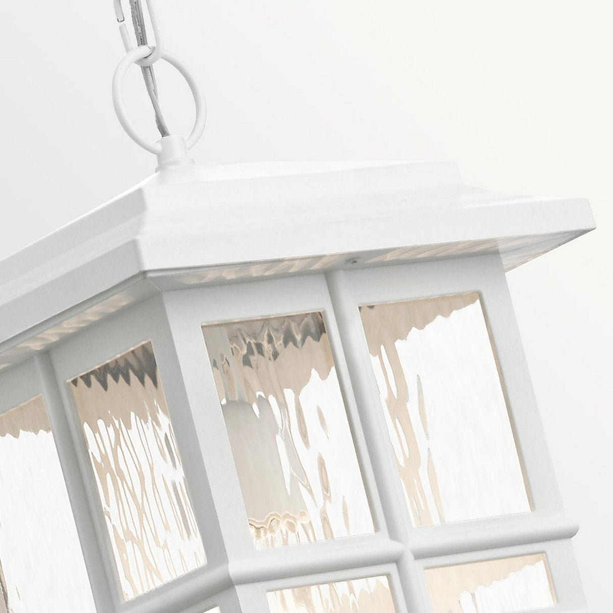 Close-up of the Beacon Square Outdoor 1 Light Chain Lantern in white, featuring textured glass panels and suspended by a metal chain. The lantern showcases a classic, rectangular Craftsman-inspired design set against a plain, light background.