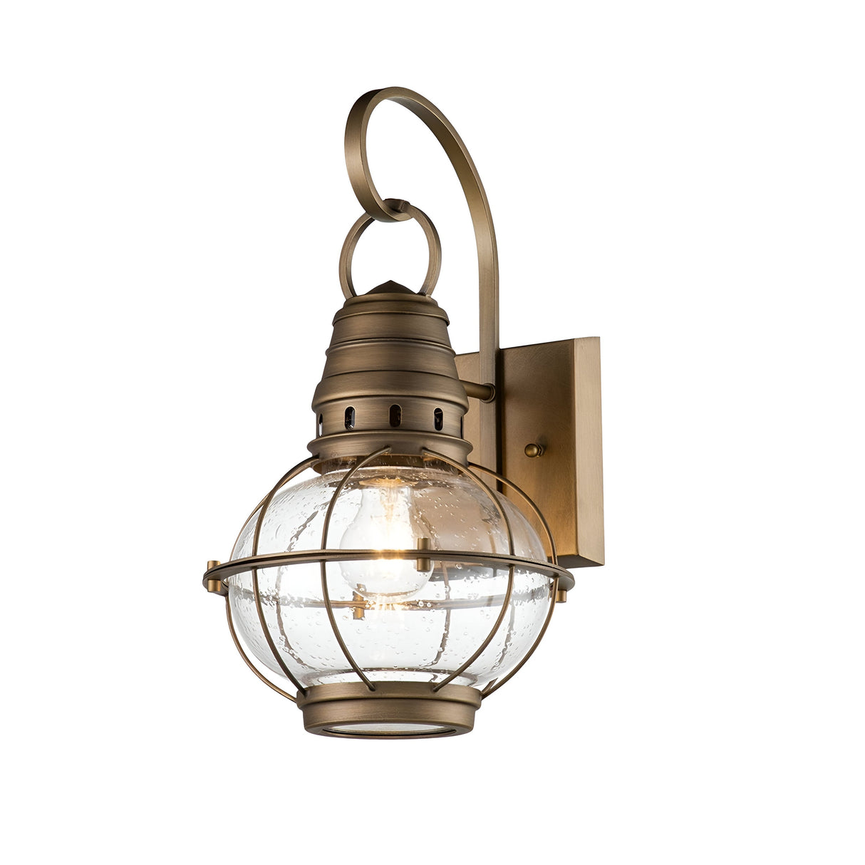 Introducing the Bridgepoint Outdoor 1 Light Medium Wall Lantern, an elegantly vintage nautical-style lighting fixture. It showcases a natural brass finish with a distinctive spherical glass cover securely enclosed in a metal cage design. This lantern is mounted on a refined curved arm and complemented by a rectangular wall plate.