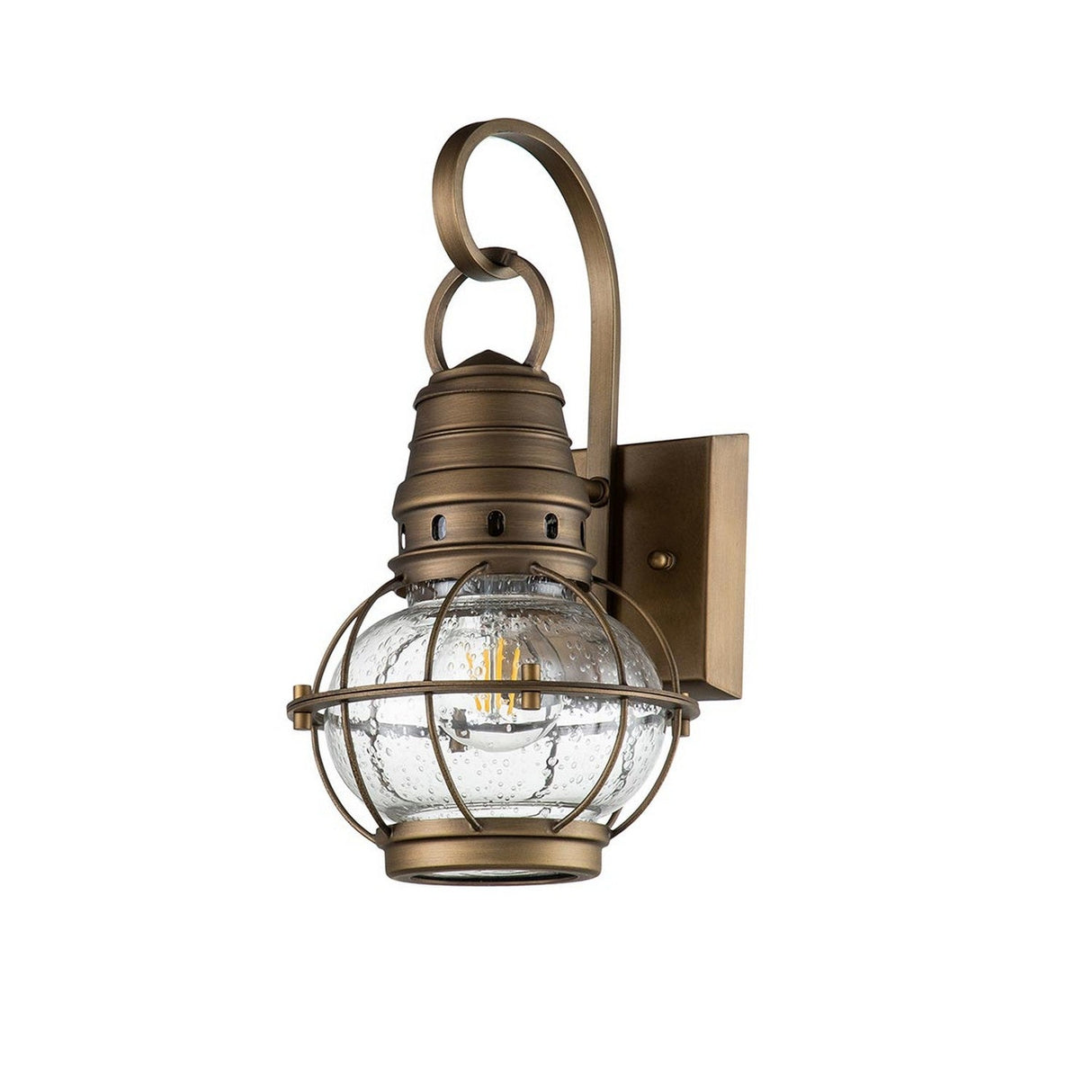 Introducing the Bridgepoint Outdoor 1 Light Small Wall Lantern in Natural Brass, this captivating nautical piece showcases a vintage design. It features a clear glass globe with bubble details secured within a protective metal cage. The charming brass lantern is mounted on an elegant scroll arm connected to a rectangular backplate, infusing any space with seaside charm.