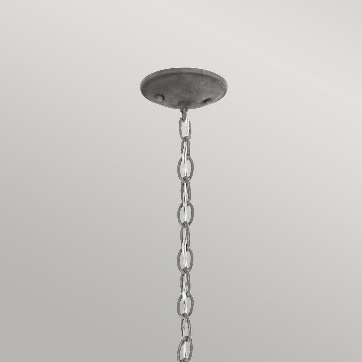 A Bridge Point Outdoor 1 Light Small Chain Light in weathered zinc descends before a gray background, hanging from a round ceiling mount. The chain links, evoking nautical charm, are evenly spaced.