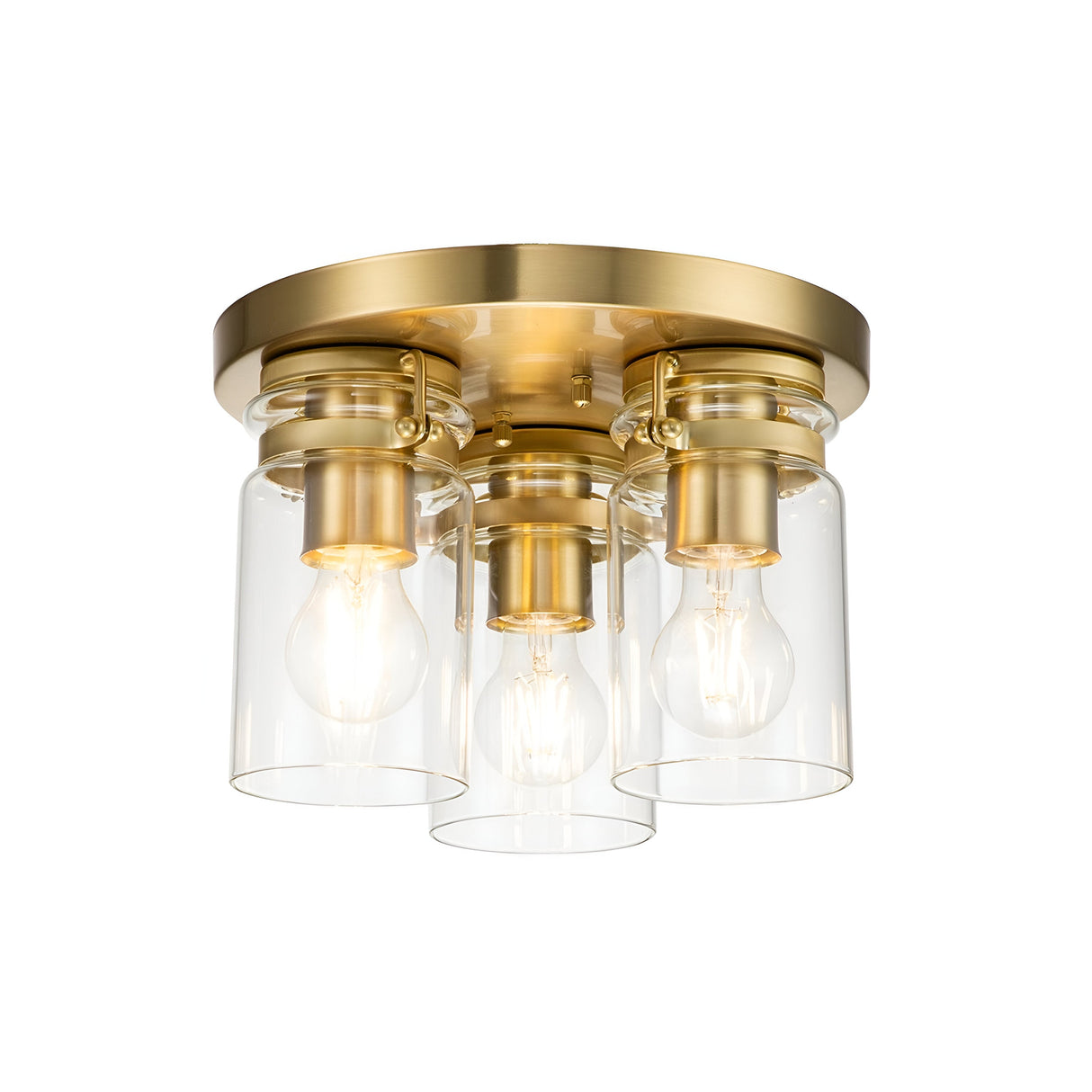 The Brinley 3 Light Flush - Brushed Brass ceiling fixture offers a modern design with vintage inspiration. It features three exposed bulbs beautifully encased in clear cylindrical glass shades, all mounted on a circular base.